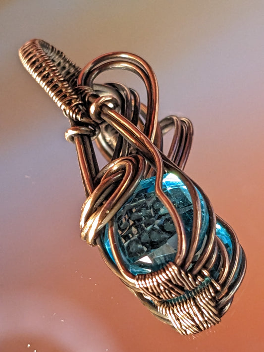 Copper wire wrapped pendant with London blue topaz faceted stone